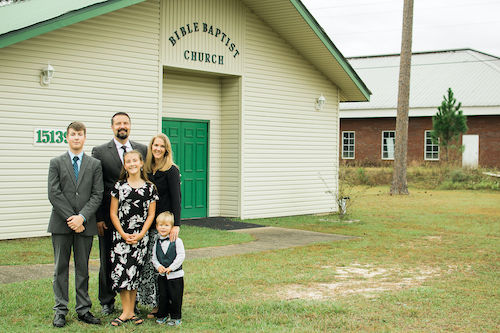 photo of pastor family in front of church